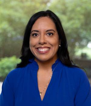 female headshot wearing a bright blue shirt