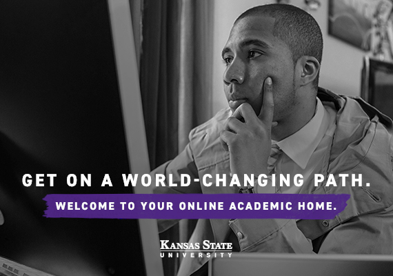 K-State Online student sitting in front of computer working on online course