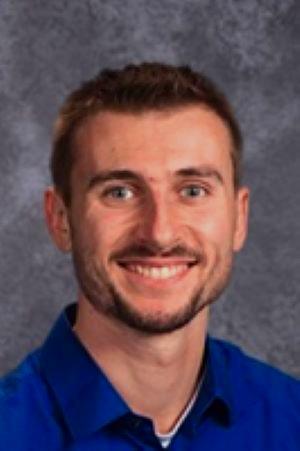 male headshot wearing a blue shirt